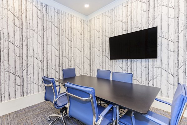 Bright home office with ergonomic chair and large desk at Wyldewood Gosling Apartments, perfect for remote work or study tasks