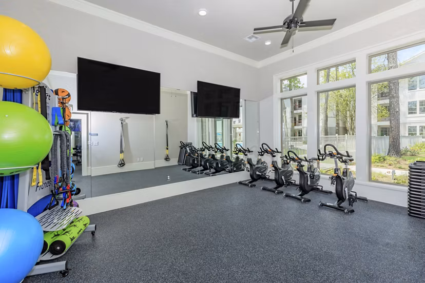Fitness center with modern equipment at Wyldewood Gosling Apartments offering residents a premier workout experience