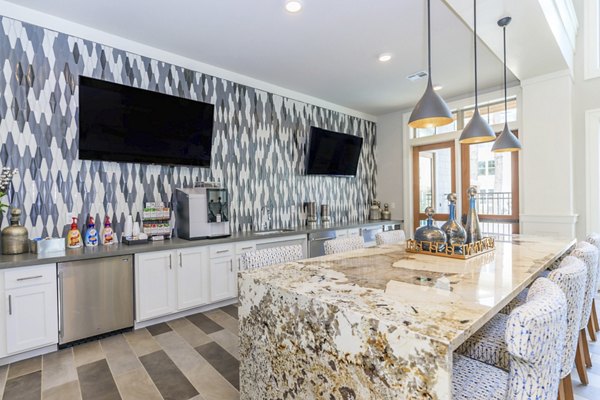 Modern kitchen with sleek appliances and island in Wyldewood Gosling Apartments