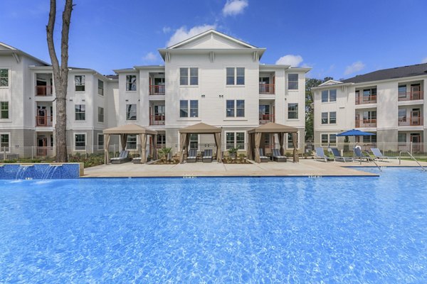 Resort-style pool with lounge chairs at Wyldewood Gosling Apartments offering luxurious relaxation