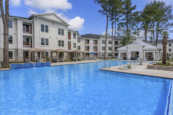 Resort-style pool area with loungers at Wyldewood Gosling Apartments, perfect for relaxation and social gatherings