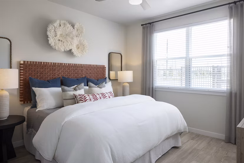 Modern bedroom featuring cozy queen bed and stylish decor at Prose Sterling Apartments