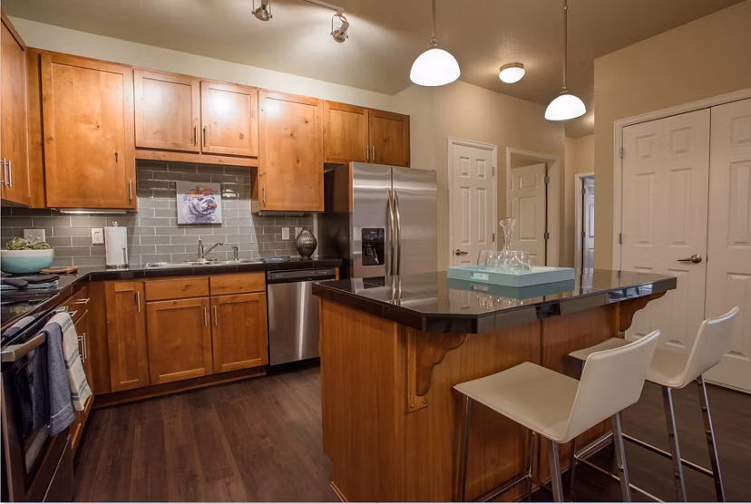 Modern kitchen with stainless steel appliances at Whisper Sky Apartments, offering luxury living spaces