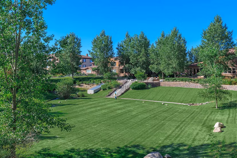 Charming courtyard at Whisper Sky Apartments featuring lush greenery and seating areas