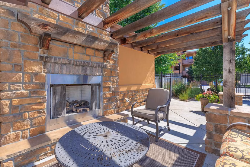 Fire pit surrounded by seating at Whisper Sky Apartments in luxury courtyard setting
