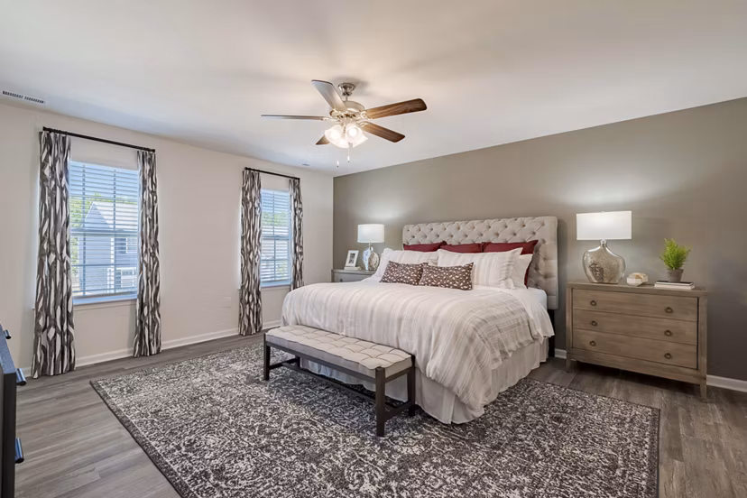 Cozy bedroom with modern furnishings at Summerwell Harmony Apartments