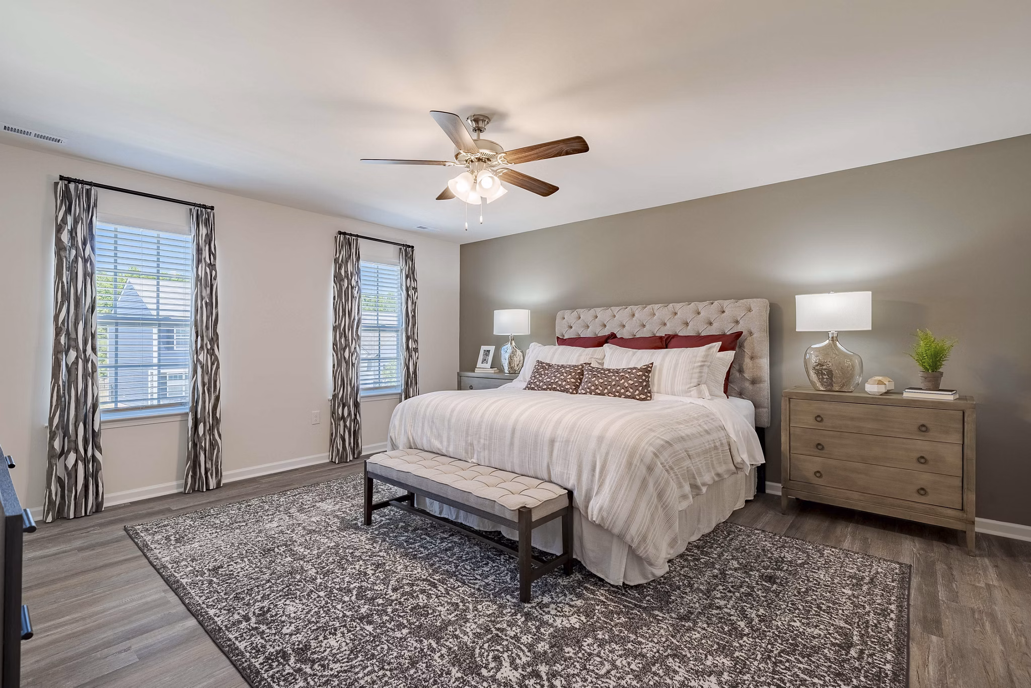 Cozy bedroom with modern furnishings at Summerwell Harmony Apartments