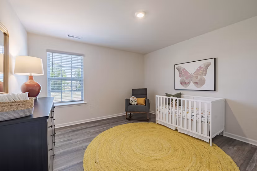 Cozy bedroom with modern decor at Summerwell Harmony Apartments, a luxury property by Greystar