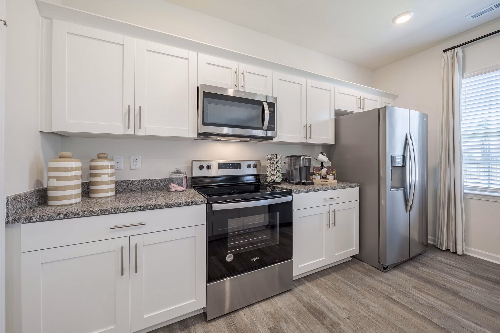 Cozy kitchen with modern appliances in Summerwell Harmony Apartments