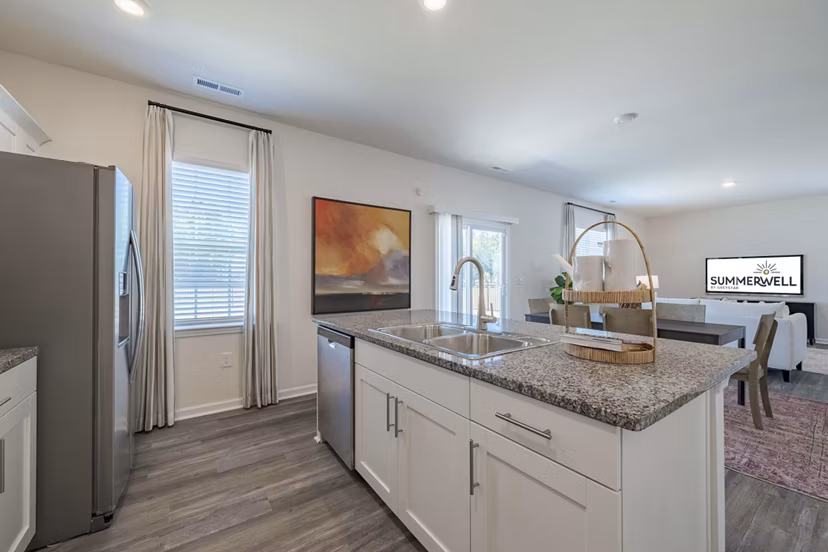 Modern kitchen with stainless steel appliances at Summerwell Harmony Apartments