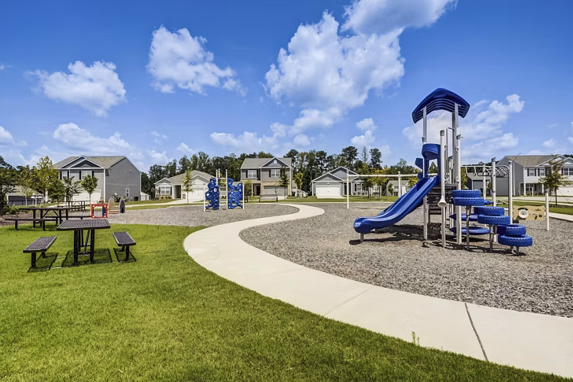 Modern playground at Summerwell Harmony Apartments, featuring colorful slides and climbing structures for family-friendly outdoor fun