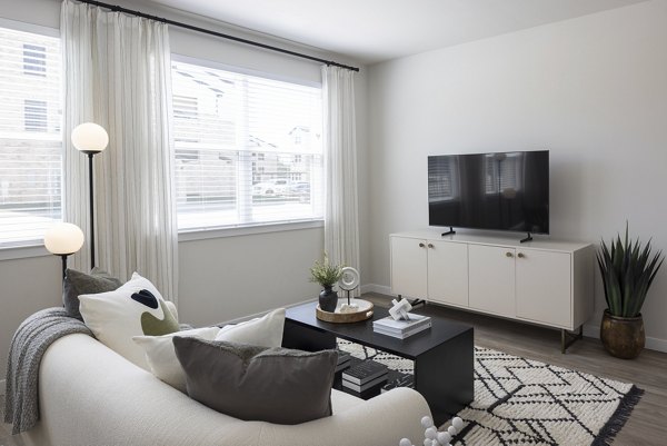 Living room featuring modern decor and natural light in Prose Thunder Rock Apartments