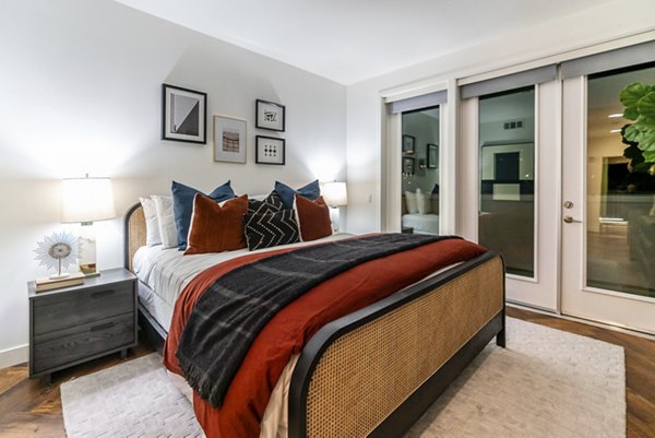 Cozy bedroom with modern furnishings at Fitz on Fairfax Apartments