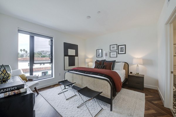 Cozy bedroom with designer furnishings at Fitz on Fairfax Apartments, Los Angeles