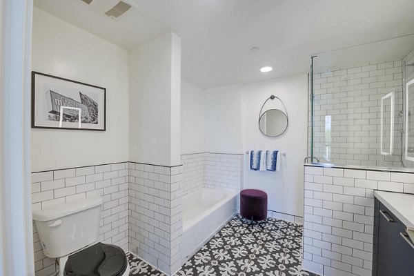 Modern bathroom with marble countertops and sleek fixtures at Fitz on Fairfax Apartments, luxury community in Los Angeles