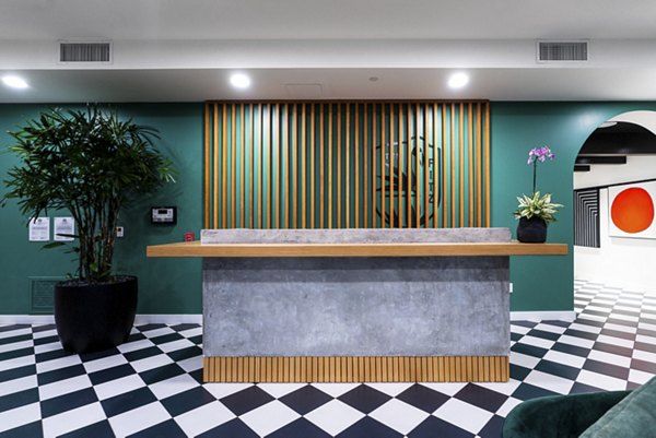 Modern clubhouse with stylish seating and entertainment space at Fitz on Fairfax Apartments