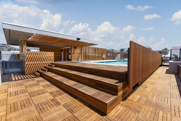 Resort-style pool with lounge chairs at Fitz on Fairfax Apartments in Los Angeles