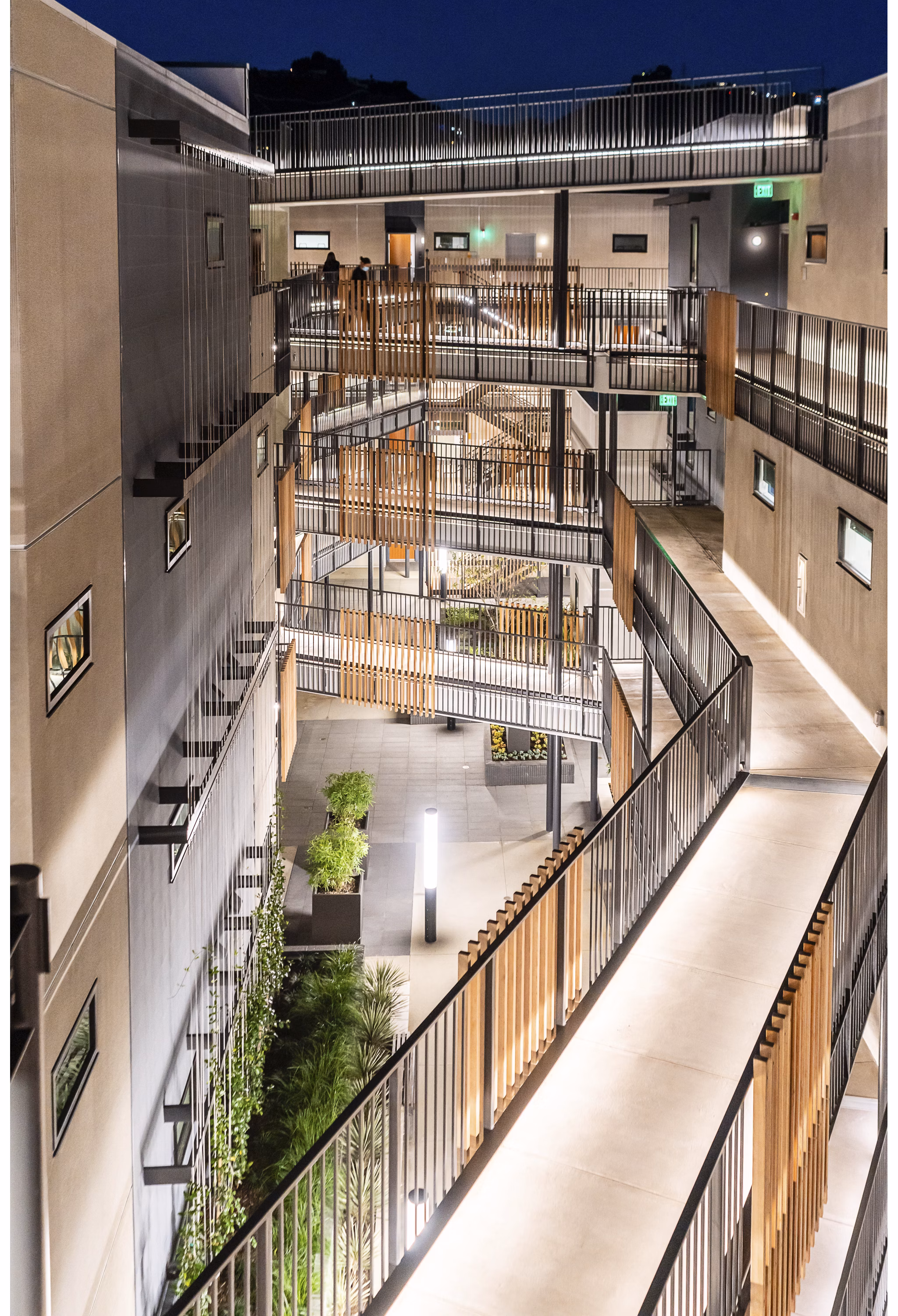 Courtyard with lush greenery and seating at Fitz on Fairfax Apartments