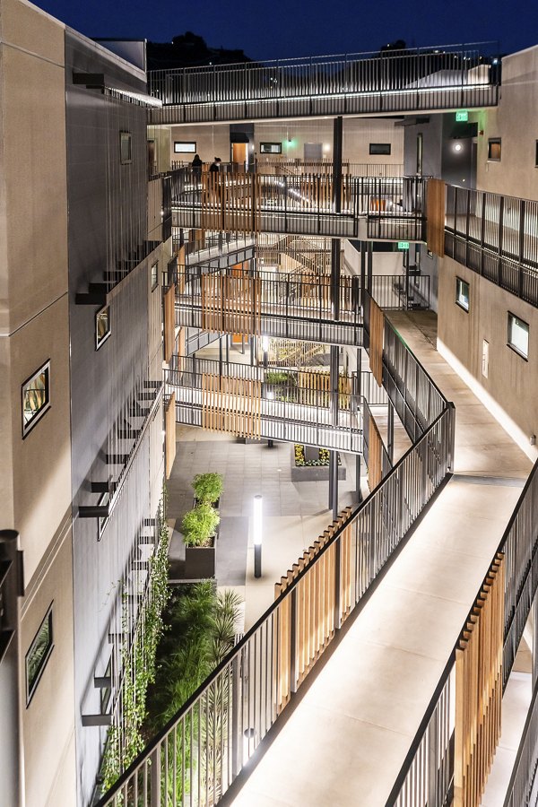 Courtyard with lush greenery and seating at Fitz on Fairfax Apartments