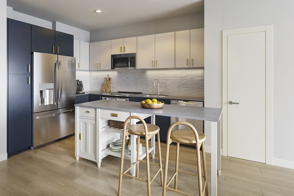 Modern dining room with sleek furniture and pendant lighting in Maxwell Apartments