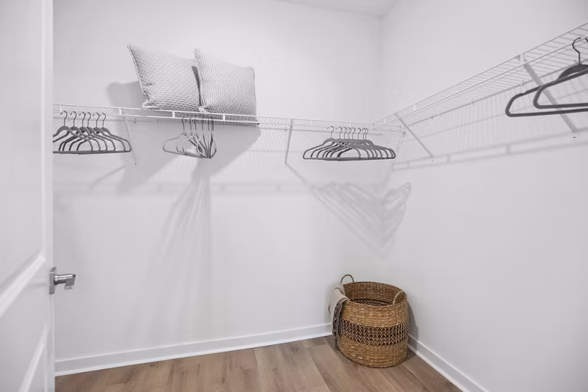 Spacious bedroom closet with custom shelving at River Rock at Dallas Apartments