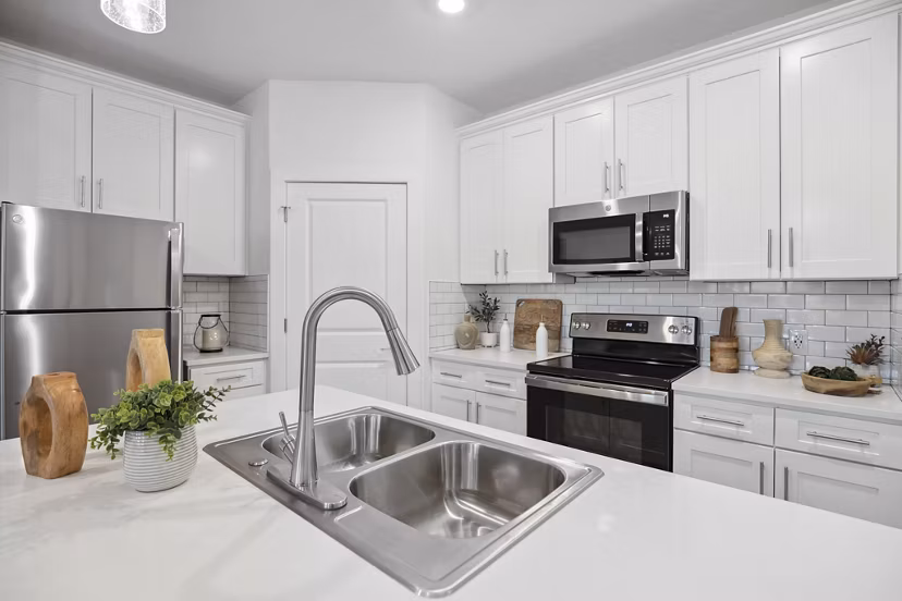 Modern kitchen with stainless steel appliances at River Rock at Dallas Apartments