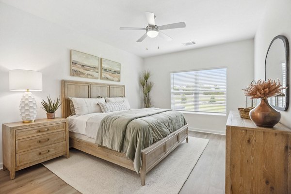 Modern bedroom with stylish decor at River Rock at Shingletree Apartments, featuring a cozy ambiance for luxury living