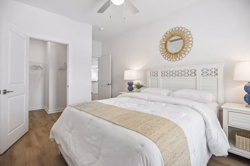 Bedroom with stylish decor and natural light at River Rock at Shingletree Apartments