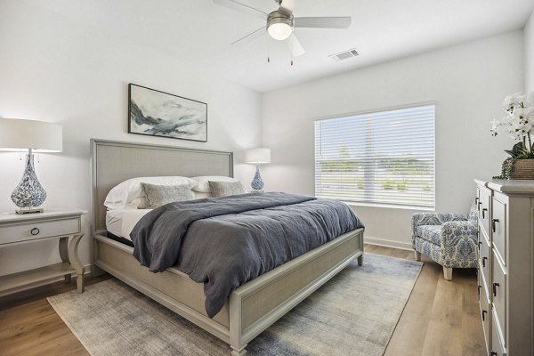 Spacious bedroom with modern furnishings at River Rock at Shingletree Apartments