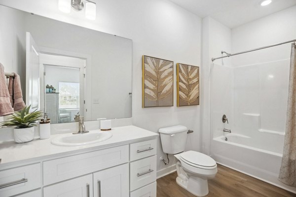 Contemporary bathroom with marble countertops and sleek fixtures at River Rock at Shingletree Apartments Elegant luxury apartment interior design