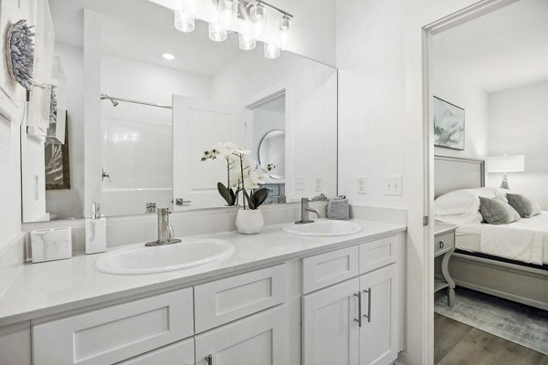 Modern bathroom with marble countertops and elegant fixtures in River Rock at Shingletree Apartments