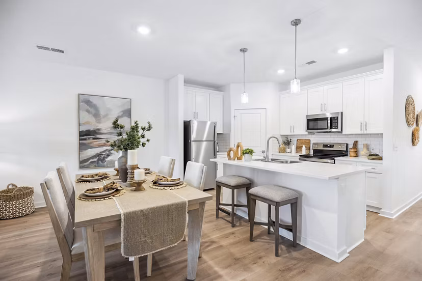 Dining room with modern furnishings and pendant lighting at River Rock at Shingletree Apartments, offering luxury apartment living