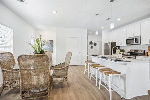 Elegant dining room with modern furnishings at River Rock at Shingletree Apartments, ideal for hosting meals and gatherings