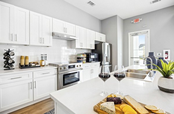 Modern kitchen with stainless steel appliances in River Rock at Shingletree Apartments offering luxury living