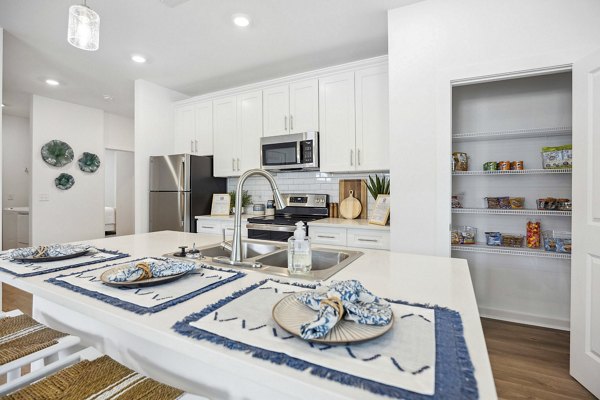 Modern kitchen with stainless steel appliances at River Rock at Shingletree Apartments