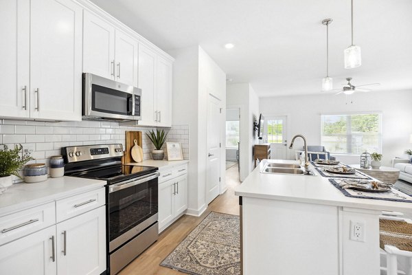 Modern kitchen with stainless steel appliances at River Rock at Shingletree Apartments