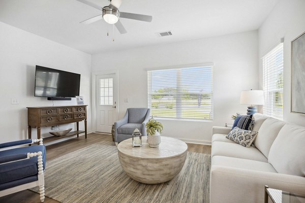 Spacious living room with modern decor at River Rock at Shingletree Apartments