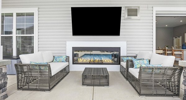 Cozy fire pit on a modern patio at River Rock at Shingletree Apartments