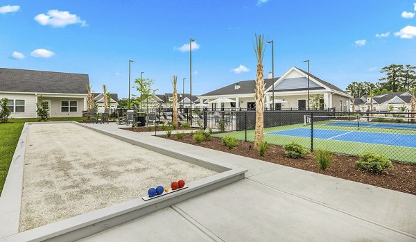 Recreational area with tennis courts and picnic spots at River Rock at Shingletree Apartments