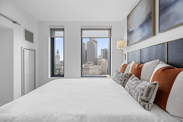 Elegant bedroom with modern decor at The Sudbury Apartments, featuring natural light and a serene color palette Ideal for comfortable luxury living