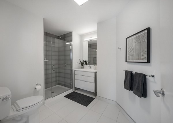 Modern bathroom with marble countertops and sleek fixtures in The Sudbury Apartments