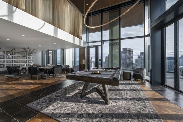 Clubhouse game room with pool table and lounge area at The Sudbury Apartments â€“ perfect for socializing and relaxation