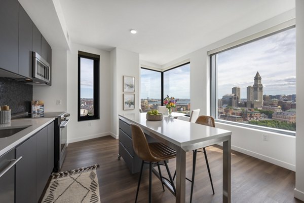 Modern dining and kitchen area with sleek countertops at The Sudbury Apartments