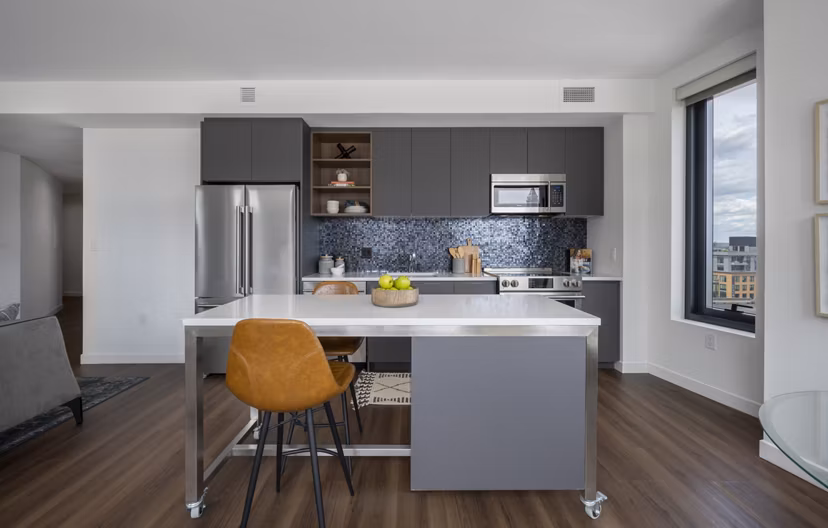 Modern kitchen featuring sleek countertops and stainless steel appliances at The Sudbury Apartments