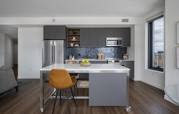 Modern kitchen featuring sleek countertops and stainless steel appliances at The Sudbury Apartments