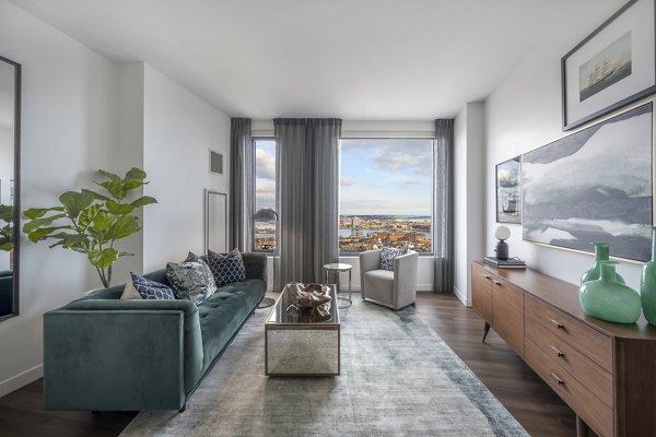 Living room with designer furnishings and large windows at The Sudbury Apartments, luxury living in the heart of the city