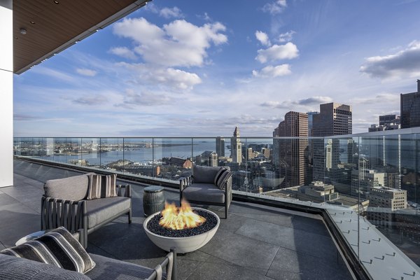 Cozy fire pit area on the patio at The Sudbury Apartments offering luxury outdoor living experience