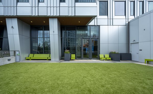 Off-leash dog park at The Sudbury Apartments featuring agility equipment and green spaces