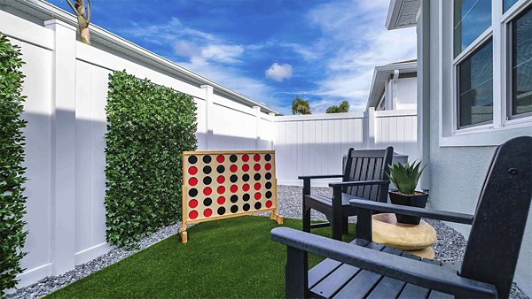 Patio with stylish seating and garden views at Yardly Bellalago Apartments