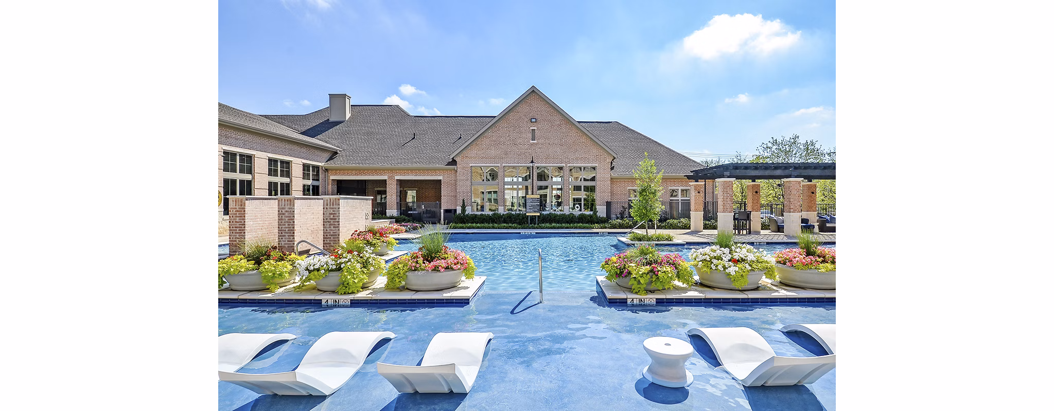 Relaxing pool area with modern loungers at Axis Kessler Park Apartments